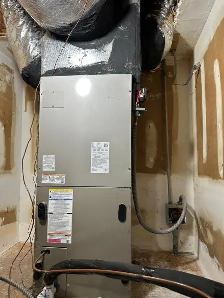 An air handler installed in a closet, with the copper lines exposed